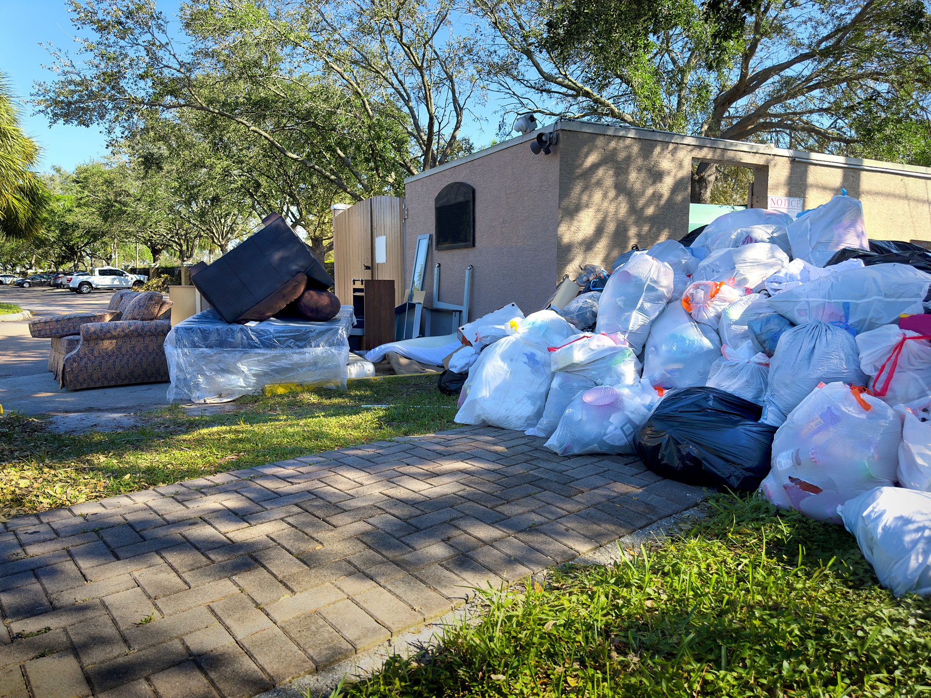 Residential garbage area with old furnitures and garbage bags